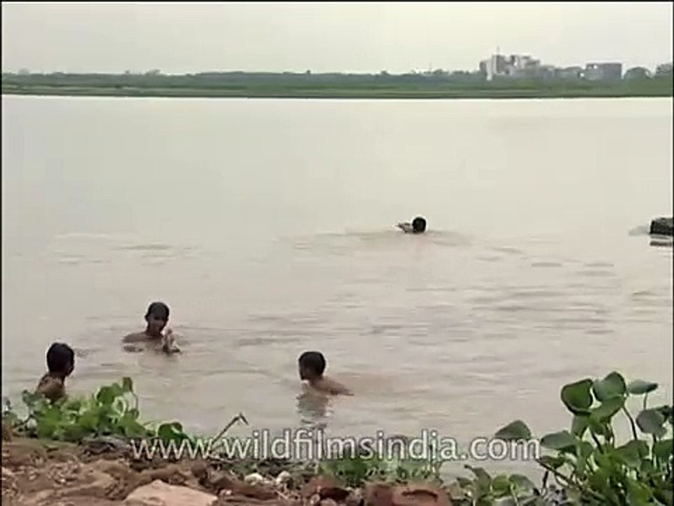 Kids splashing around in the waters of Yamuna River, Delhi