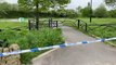 Police activity at the scene the day after a murder at Manor Fields Park.