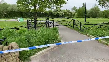 Police activity at the scene the day after a murder at Manor Fields Park.