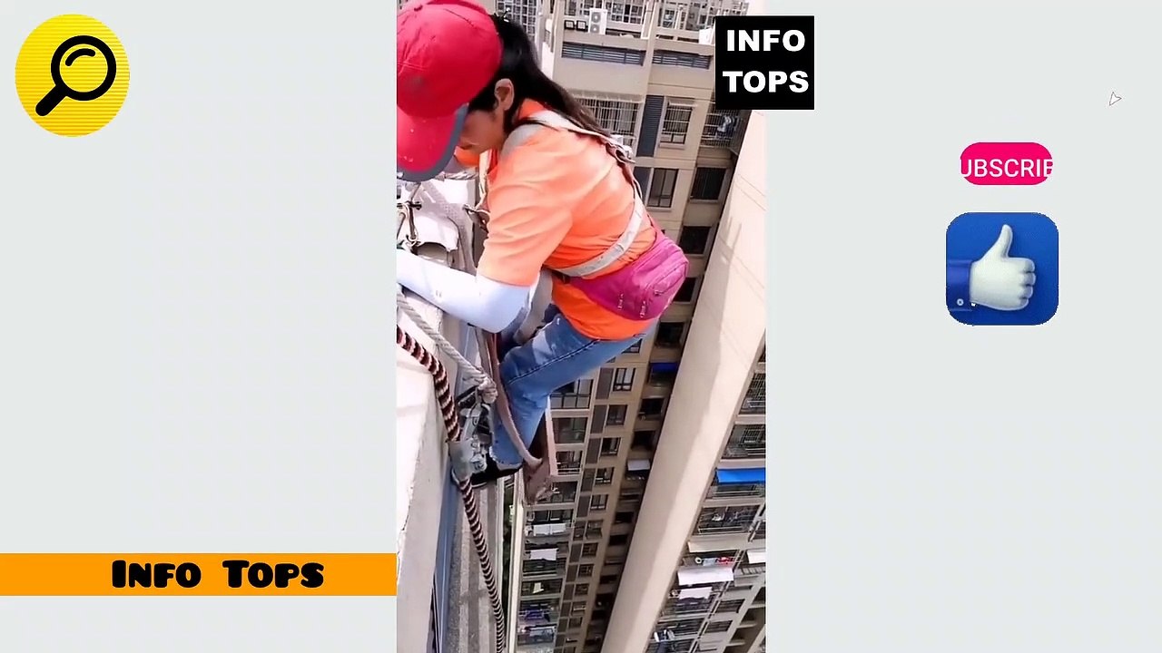  Team of workers painting wall high rise building 