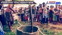 Villagers gather to watch a twelve feet long python in Garbeta