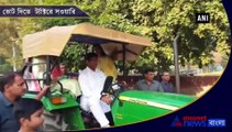 JJP leader Dushyant Chautala arrives on tractor to cast his vote