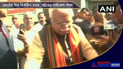 Manohar Lal Khattar rides a cycle to the polling booth