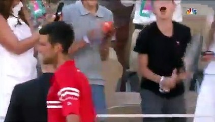 Novak Djokovic presents his title winning racquet and cap to small fan's after win the French Open 2021 spb