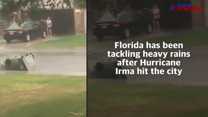 Hurricanes in Florida may come and go, but nothing can stop this woman from cleaning her car