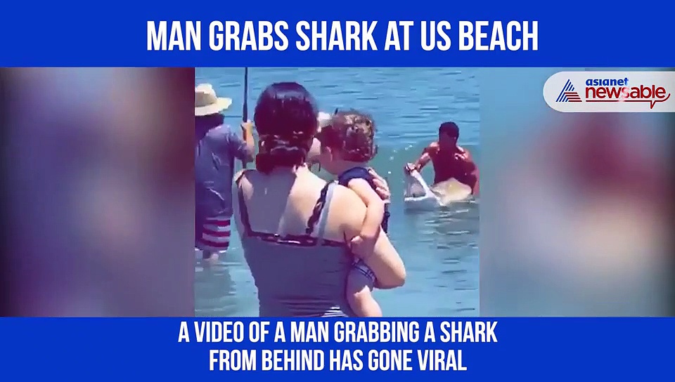 Watch: Man grabs shark with bare hands, opens its jaws