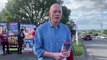 Peter Garrett shows his support for Labor as Fiona Phillips casts her vote on Election Day