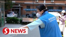 Visually impaired volunteer assists Covid-19 fight in Beijing