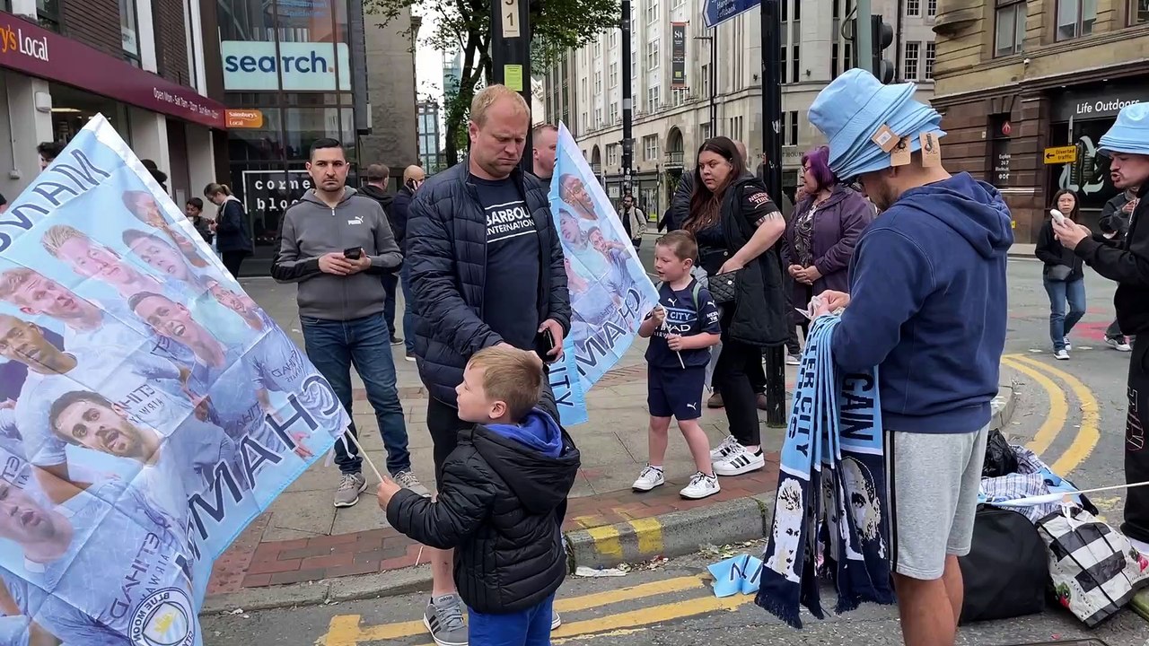 Manchester City fans celebrate at the victory parade