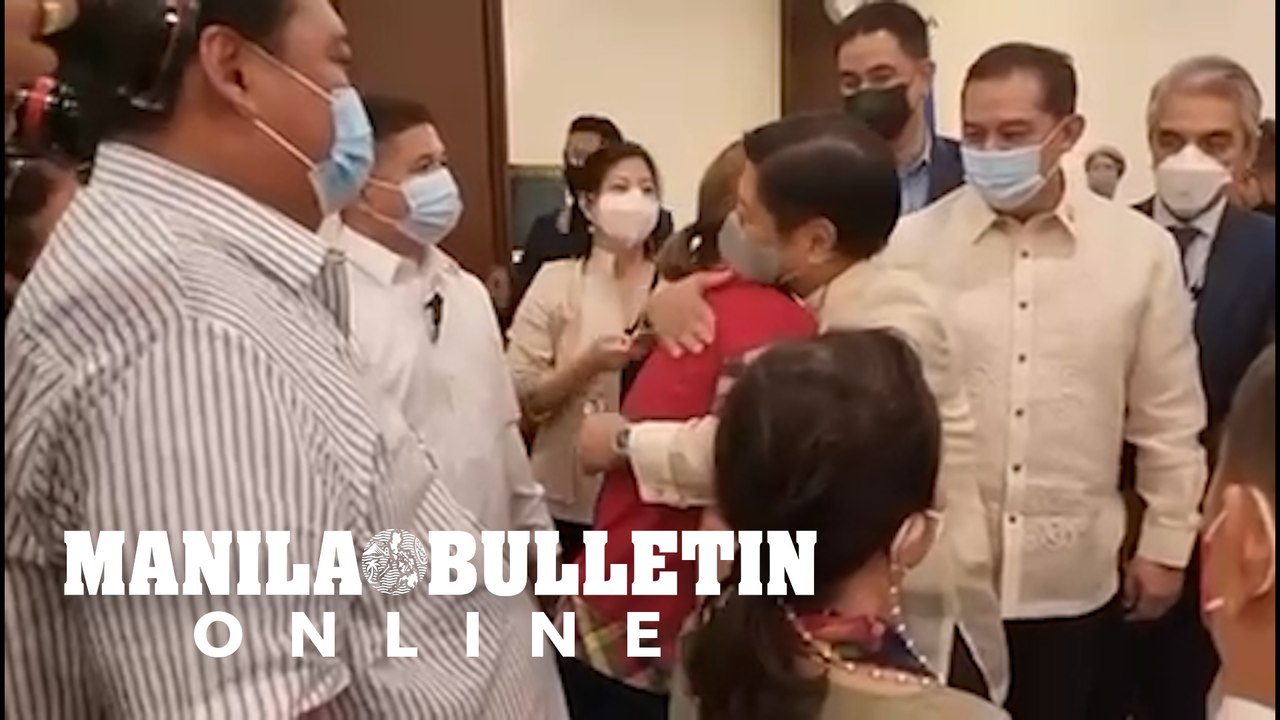 Bongbong Marcos Jr. and Sara Duterte greet each other with a tight embrace while waiting for their proclamation