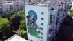 Giant mural of armed saint painted on Kyiv building