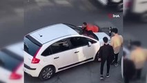 Motosikletini çarpıp kaçmak isteyen kadını, otomobilinin üzerine çıkarak durdurmaya çalıştı