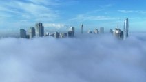 Aerial footage shows major metropolis shrouded in dense morning fog