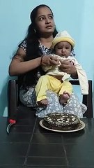 Cute Baby cutting his Birthday Cake with his Mom
