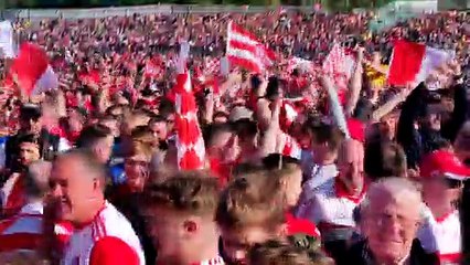 Derry players and fans celebrate Derry's Ulster Championship victory on the Clones pitch after the game