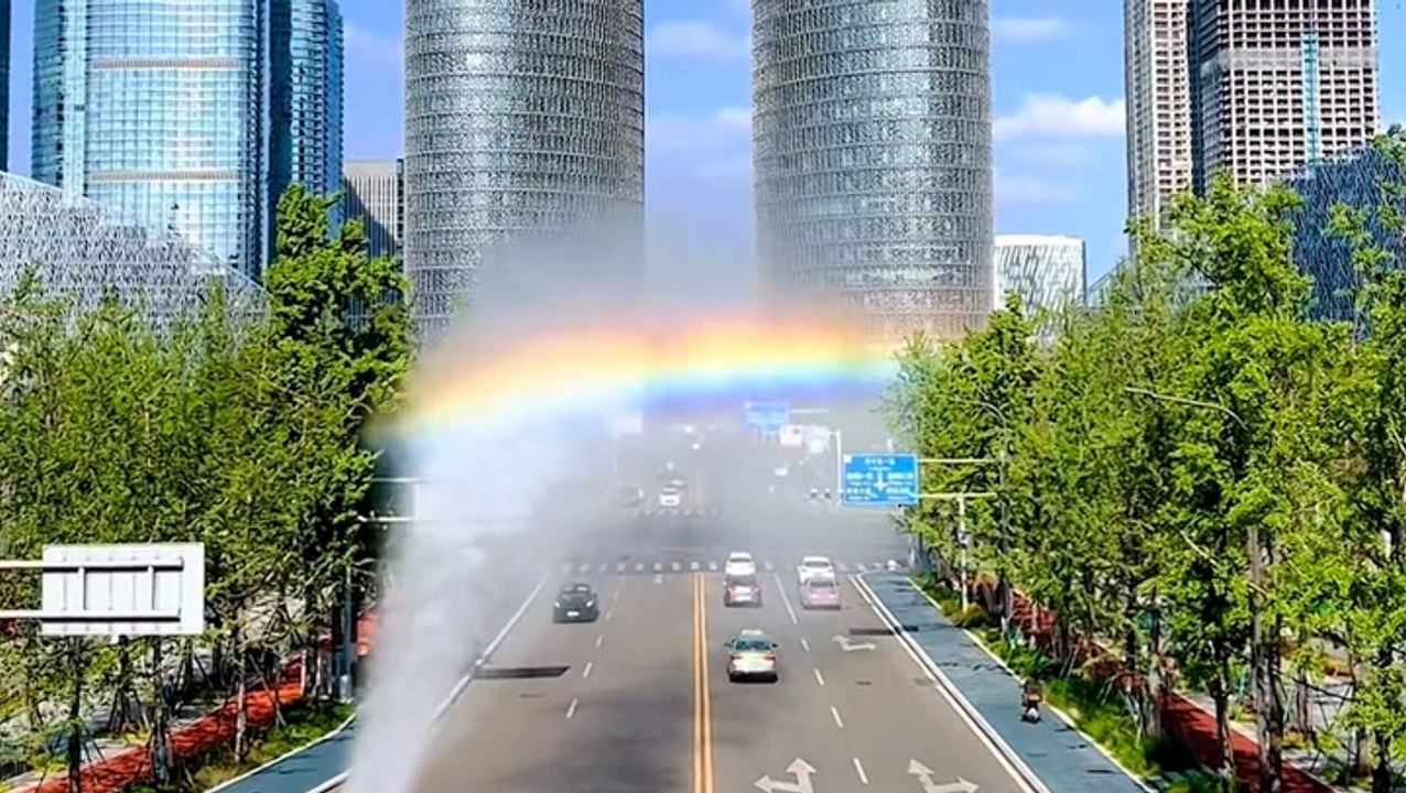Rainbow road forms after truck sprays mist