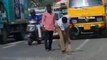 Image of the day: Traffic cop sweeps pebbles off the road in Tamil Nadu