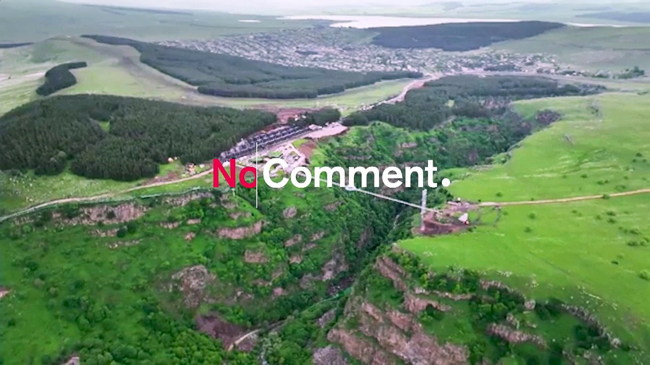 Tourists flock to 240-metre glass bridge across canyon