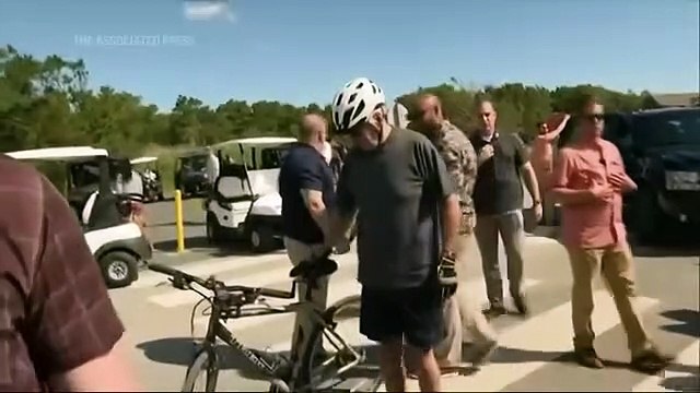 Biden tumbles getting off bike after beach ride