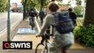 UK council build cycle lane littered with a speed camera, rubbish bins, trees and lampposts
