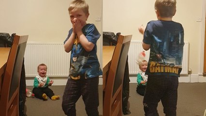 'Cheerful baby boy thoroughly enjoys watching a water bottle flying all around him '