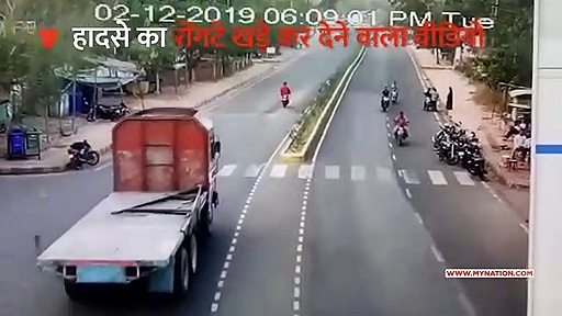 ट्रक के नीचे आने के बाद भी बाल-बाल बचा युवक (वीडियो)