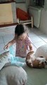 Little Girl Puts a Diaper on Her Dog