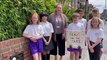 Wimborne Primary School children unveil a new plaque in memory of lollipop man Tom James