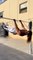 Calisthenics Trainer Performs Tricks While Hanging on Bar