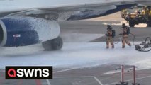 Dramatic scenes show firefighters tackling a fire on a British Airways passenger plane