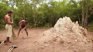 Building underground hut with grass roof & fireplace with clay