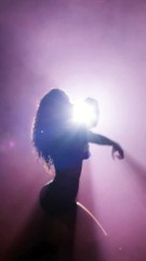 silhouette of urban dancer in smoke creating arts