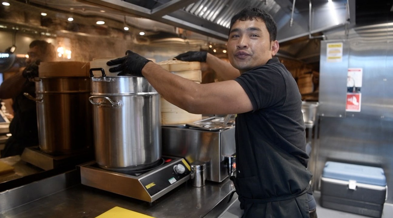 Tikk Poolsawat at Yoi Fried Chicken in Trinity Kitchen, Leeds making Thai Chicken Satay Bao Buns