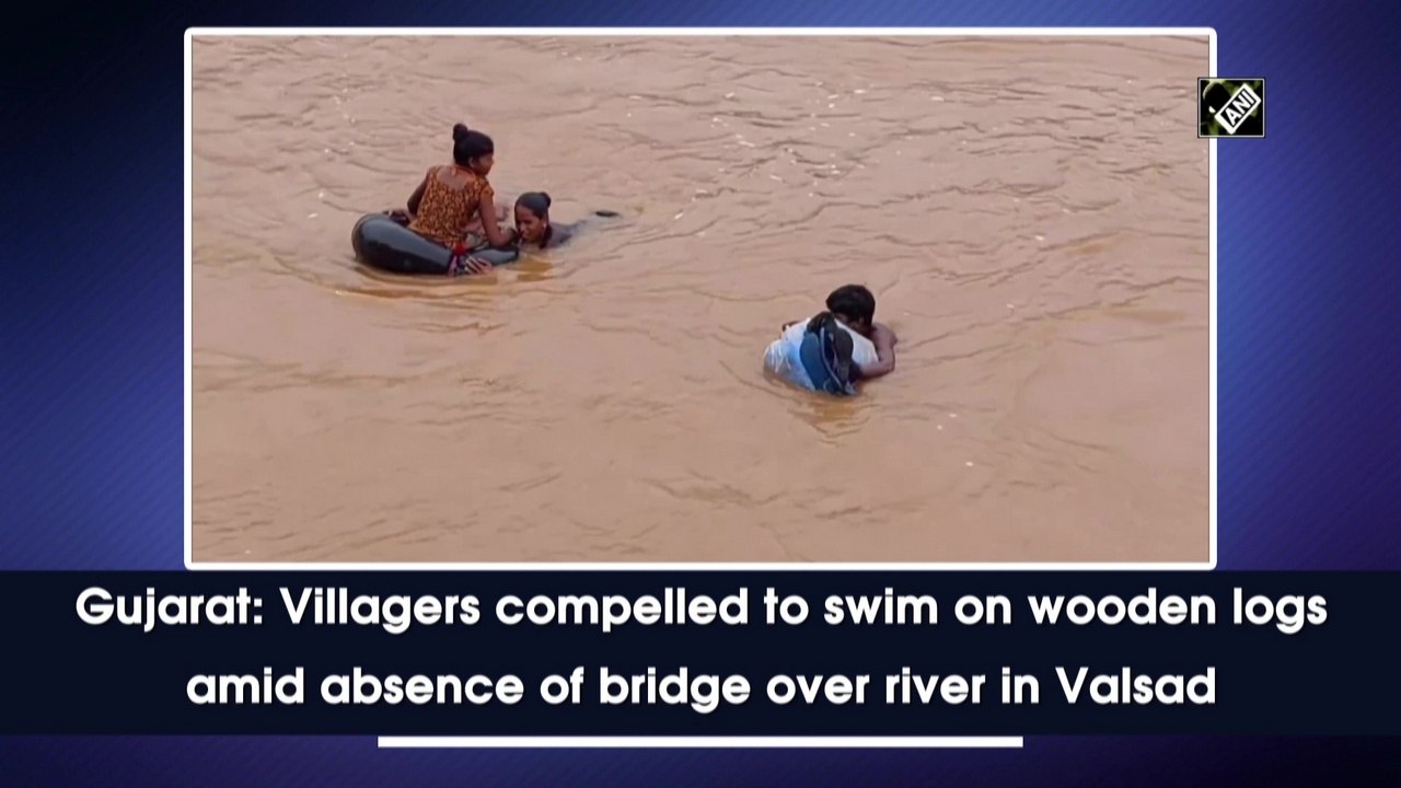 Gujarat: Villagers compelled to swim on wooden logs amid absence of bridge over river in Valsad