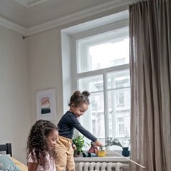 Kids Plying catch the bait with their cat in the badroom