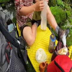 Solo camping under the big rocks on the top of the mountain without a tent on a rainy day, strong wind & mist