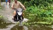 Water in ride motorbike. flood effect by road. Motorcycle ride on water. very watar on road. Fu Orpon