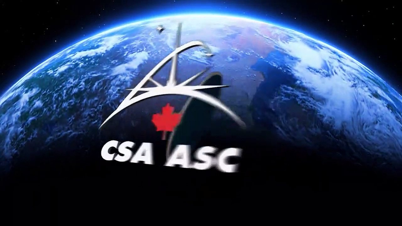 While sitting on the end of Canadarm2, Dextre is lowered into Dragon's external compartment