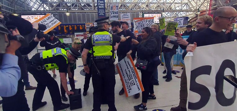 Flash mob in support of strikers are met by Police inside Central Station, Glasgow