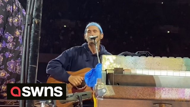 Ukrainian man performs at sold-out Coldplay gig after being approached by frontman Chris Martin while busking in Warsaw