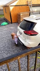 Little Girl Holds on to Opening Trunk