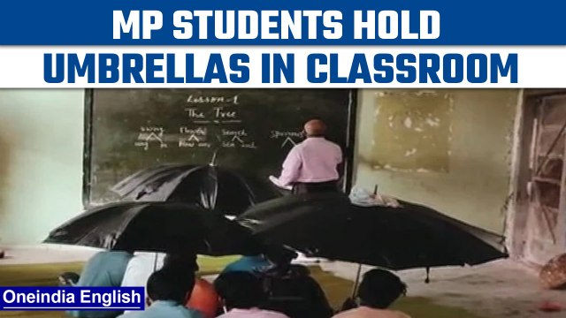 MP: Tribal students hold umbrellas in classroom as roof leaks in school | Oneindia News *viralvideo