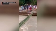 Locals use improvised bridge after flooding destroys spillway in Camarines Sur