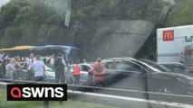 Brass band serenades stranded motorists on M6 motorway after a fire stopped traffic for hours