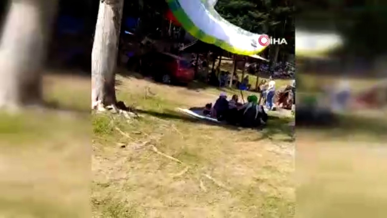Yamaç paraşütü ile piknikçilerin arasına daldı
