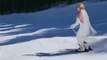 Bride and Groom Ski Down Snowy Hill After Wedding Ceremony to Their Reception