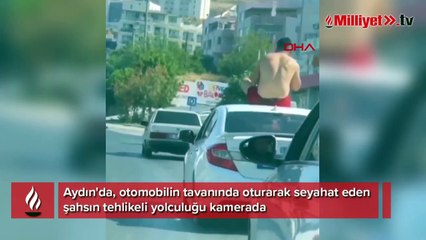 Otomobilin tavanında tehlikeli yolculuk