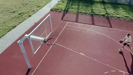 a basketball player shooting the ball in a reverse-layup