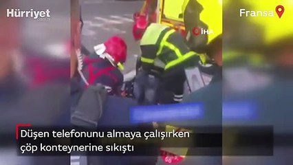 Telefonunu almaya çalışırken çöp konteynerine sıkıştı