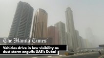 Vehicles drive in low visibility as dust storm engulfs UAE's Dubai